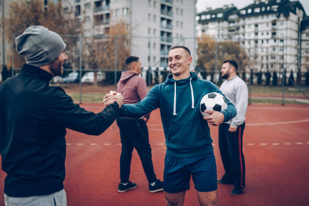 istock Best friends playing socceer on streets 938067828