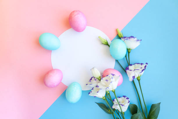 istock Easter eggs and spring flowers narcissi on blue background 938068538