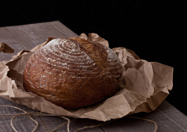 istock Freshly baked  bread with on brown oven paper 938068794