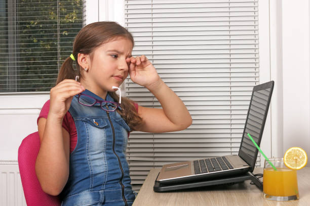 little girl are tired of using laptop stock photo