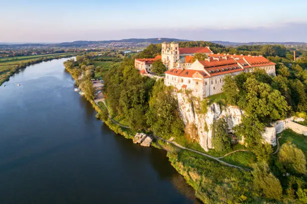 Benedictine monastery on the rocky cliff in Tyniec near Krakow, Poland, and Vistula River. Aerial view at sunset