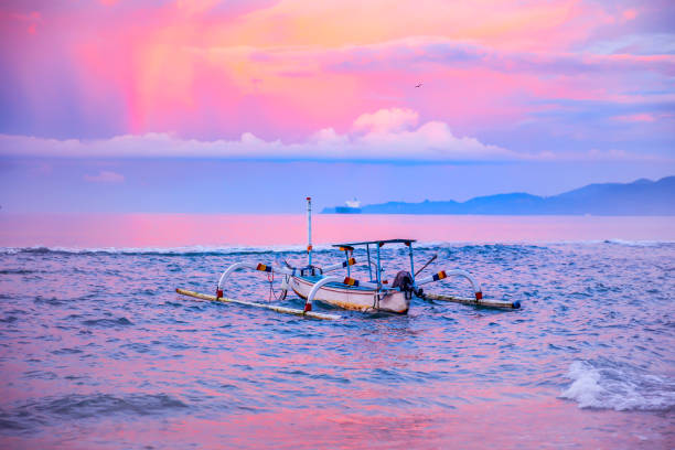 Fishing boat on the sea with rainbow in the sky