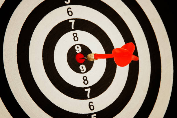istock Red darts arrow in the target center. 938072094