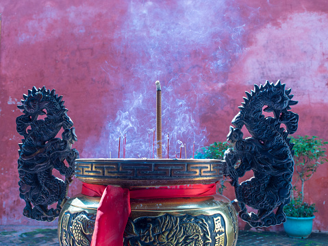 A lot of incense sticks in the pot at a temple in Taiwan