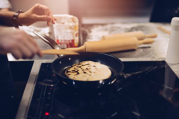 istock Frying traditional imeruli on frying pan in the kitchen. 938075478