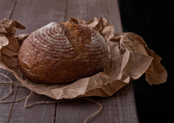 istock Freshly baked  bread with on brown oven paper 938084108