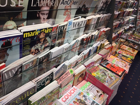 Berlin, Germany - March 15, 2018: newsstand interior, cover pages of German magazines displayed for sale on a stand