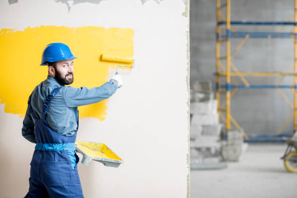 istock Repairman painting wall 938085752