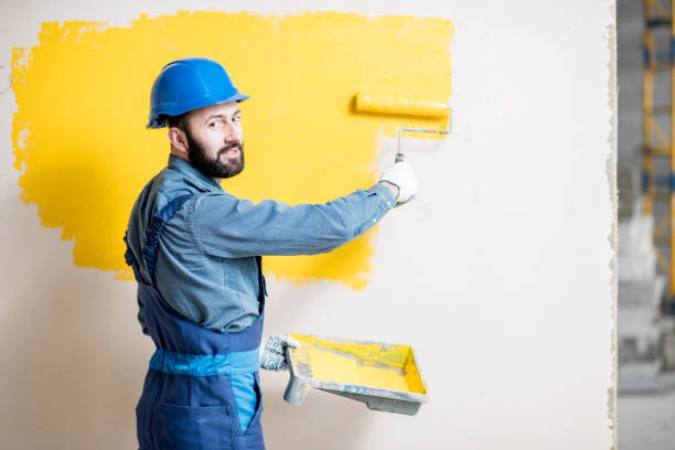 istock Repairman painting wall 938085770
