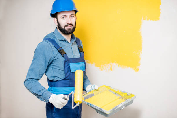 istock Repairman painting wall 938085788