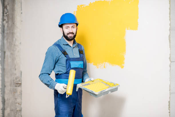 istock Repairman painting wall 938085816