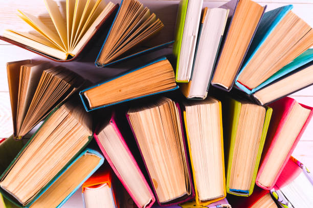 istock Open book, hardback books on bright colorful background. 938088526