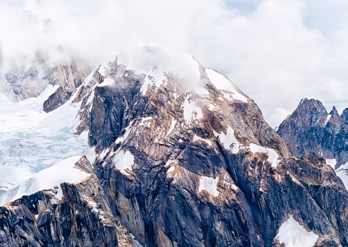 A beautiful aerial scenic view of mount McKinley wrapped in clouds, Alaska. Concept for achievement, success and adventure