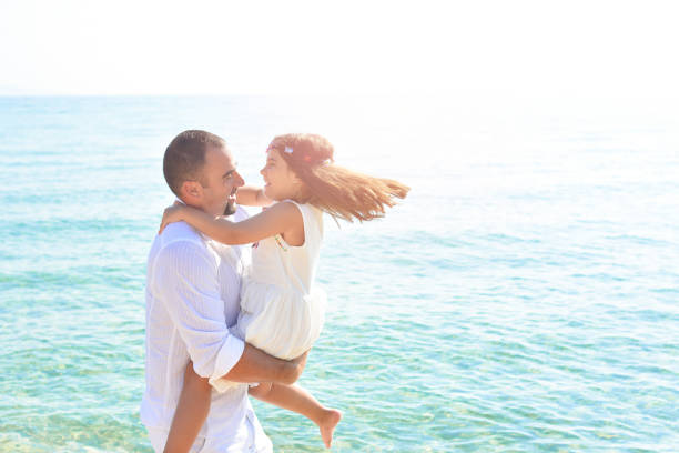 istock Father and daughter play on the beach 938089222