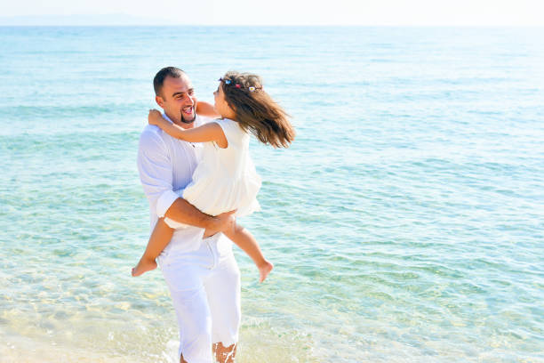 istock Father and daughter play on the beach 938089504