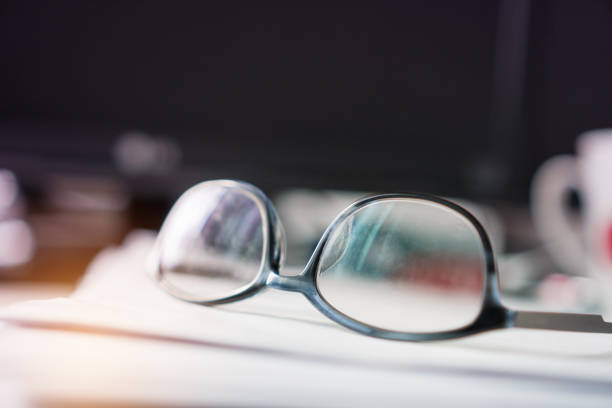 istock Document office Busy Business Concept: Eyeglasses placed on notebook documents in messy office with blur people and Busy offices and Pile of data unfinished folders on desk indoor 938092188
