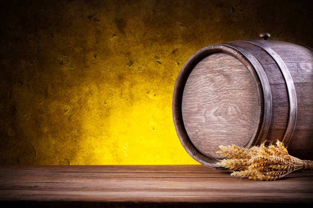 istock Wooden round barrel with spikes on yellow background 938092468