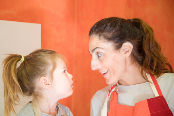 istock smiling woman with apron looking at her daughter 938093228