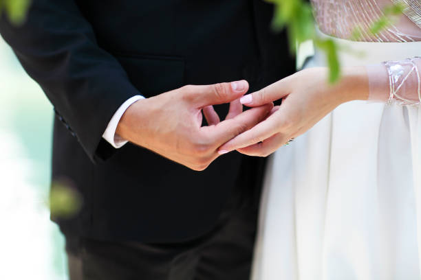 istock Wedding ceremony. Groom and bride holding hands together 938101752