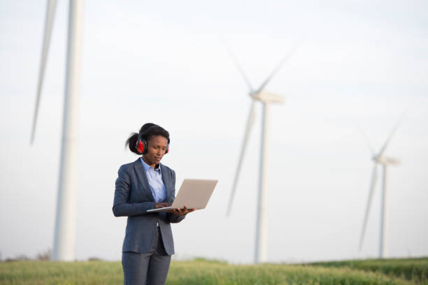 istock Energy engineer woman working with a wind turbine. 938112022