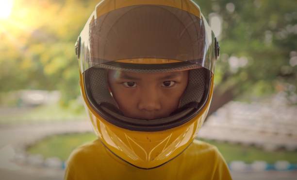 istock Asian boy wearing a motorcycle helmet. 938112216