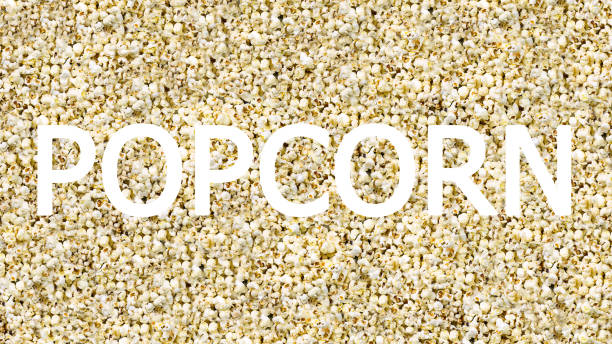 istock White inscription base word popcorn on a background of airy white corn 938112920