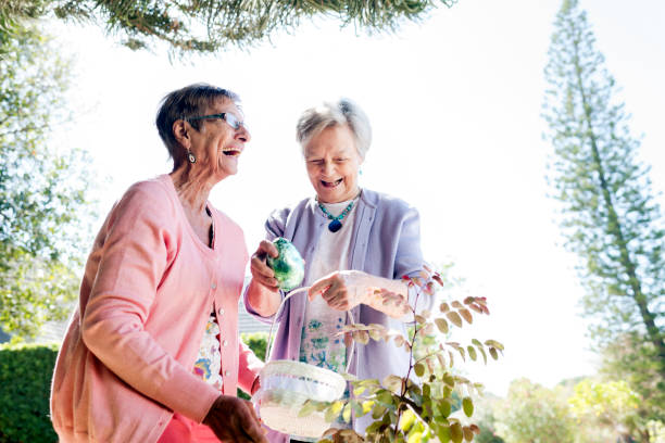 istock Senior Women placing Easter eggs in a basket 938119490