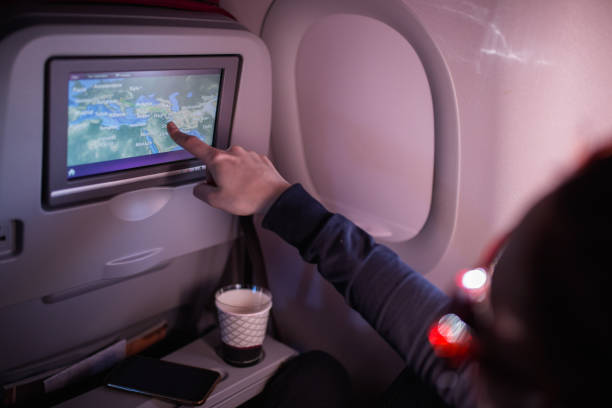 istock Woman Showing Map On Airplane Device Screen 938123108