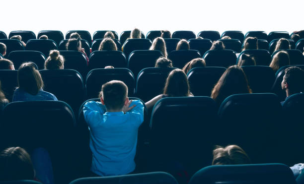 istock People watching movie in cinema hall. 938127324