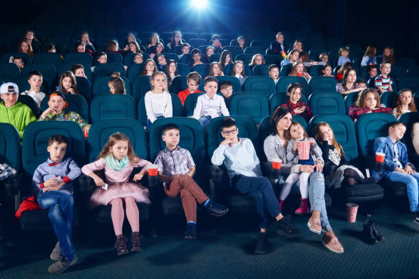 istock Frontview of people sitting in the cinema hall. 938128200