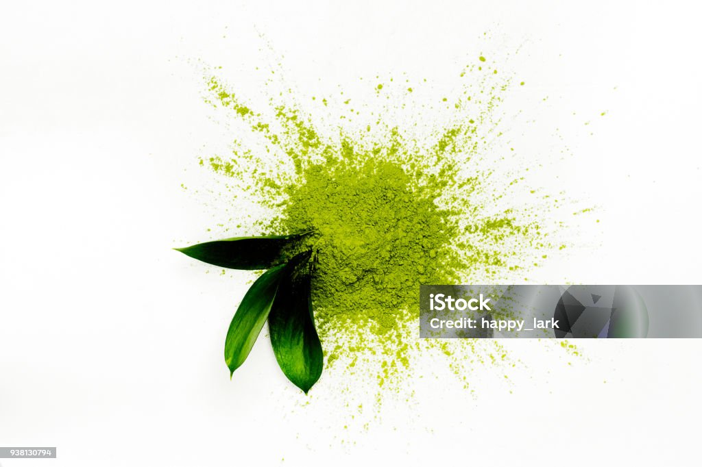 Green matcha tea powder Green matcha tea powder and leaves on white background. Copy space Ground - Culinary Stock Photo