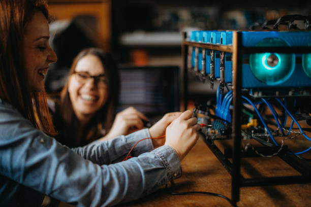 istock Two young women building a miner 938131190