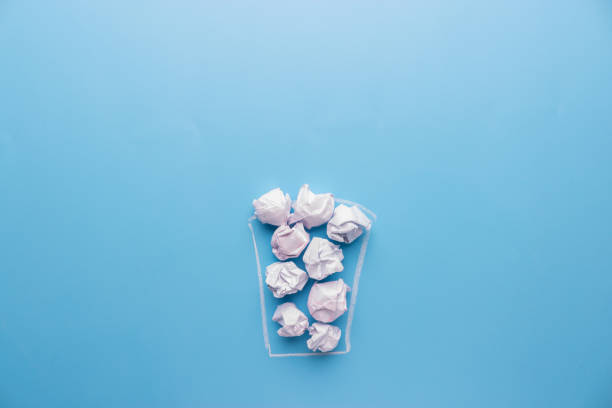 istock Concept. Creased paper in a trash can 938134176