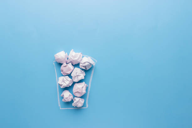 istock Concept. Creased paper in a trash can 938134194