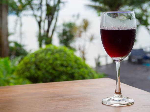 red wine in the glass against the sea.