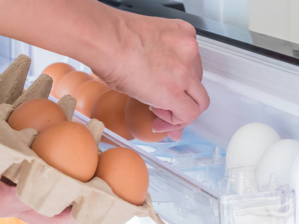 istock Hand holding eggs and store in the refrigerator.Keep it fresh. 938137980