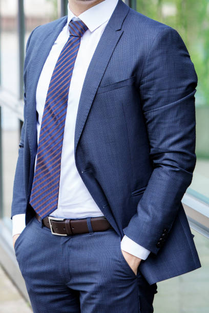 istock headless businessman in a blue suit standing outdoor 938138090