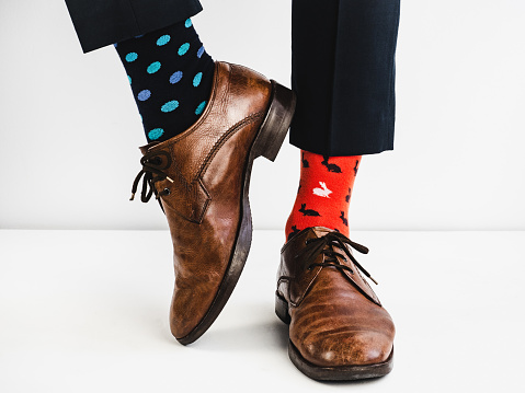 Stylish, vintage, brown shoes and bright, funny, happy socks on a white background. Style, fashion, beauty
