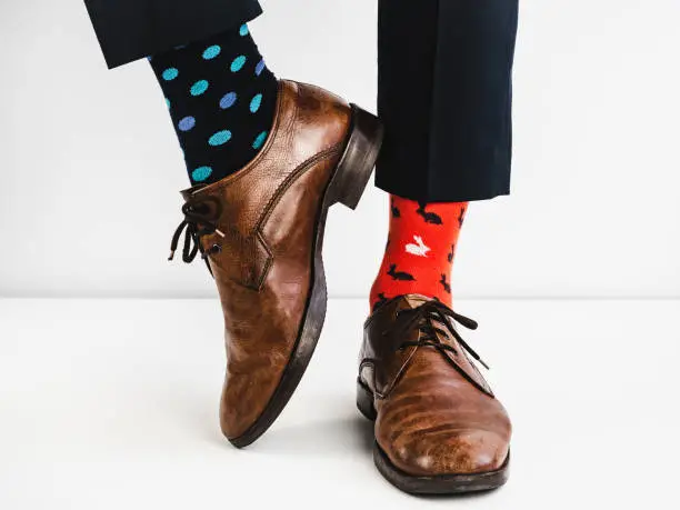 Photo of Stylish shoes and bright, funny, happy socks