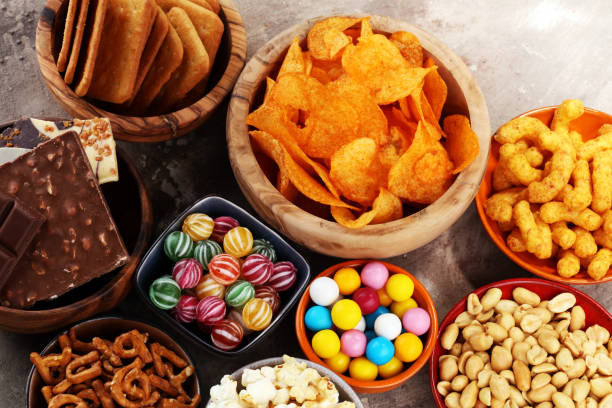istock Salty snacks. Pretzels, chips, crackers in wooden bowls. 938138658