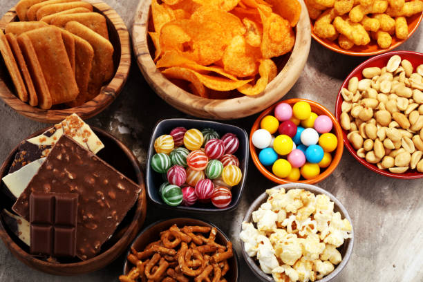 istock Salty snacks. Pretzels, chips, crackers in wooden bowls. 938140862