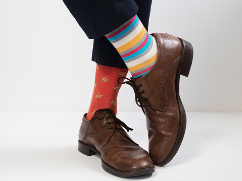 Stylish, vintage, brown shoes and bright, funny, happy socks on a white background. Style, fashion, beauty