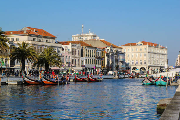 Canal with boats in Aveiro, Portugal Canal with boats in Aveiro, Portugal gondola traditional boat photos stock pictures, royalty-free photos & images