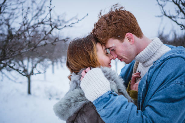 Close up of a happy couple kissing passionately on the farm while in an embrace.