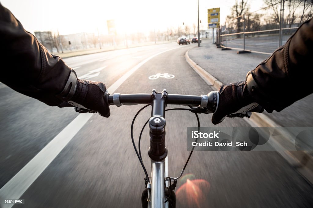 First-person view of cyclist at morning First-person view of cyclist in the city at morning Cycling Stock Photo