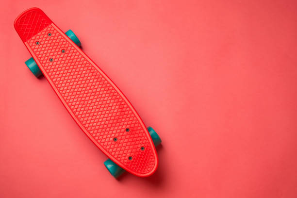 istock red skateboard with blue wheels on pink background. pastel creat 938145730