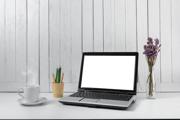 istock workplace background with Blank white screen modern laptop computer. White wooden vintage blackground 938145734
