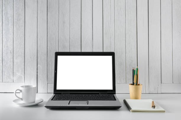 istock workplace background with Blank white screen modern laptop computer. White wooden vintage blackground 938145800