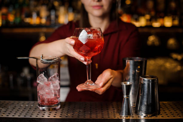 istock Bartender girl serving a red campari cocktail 938154506