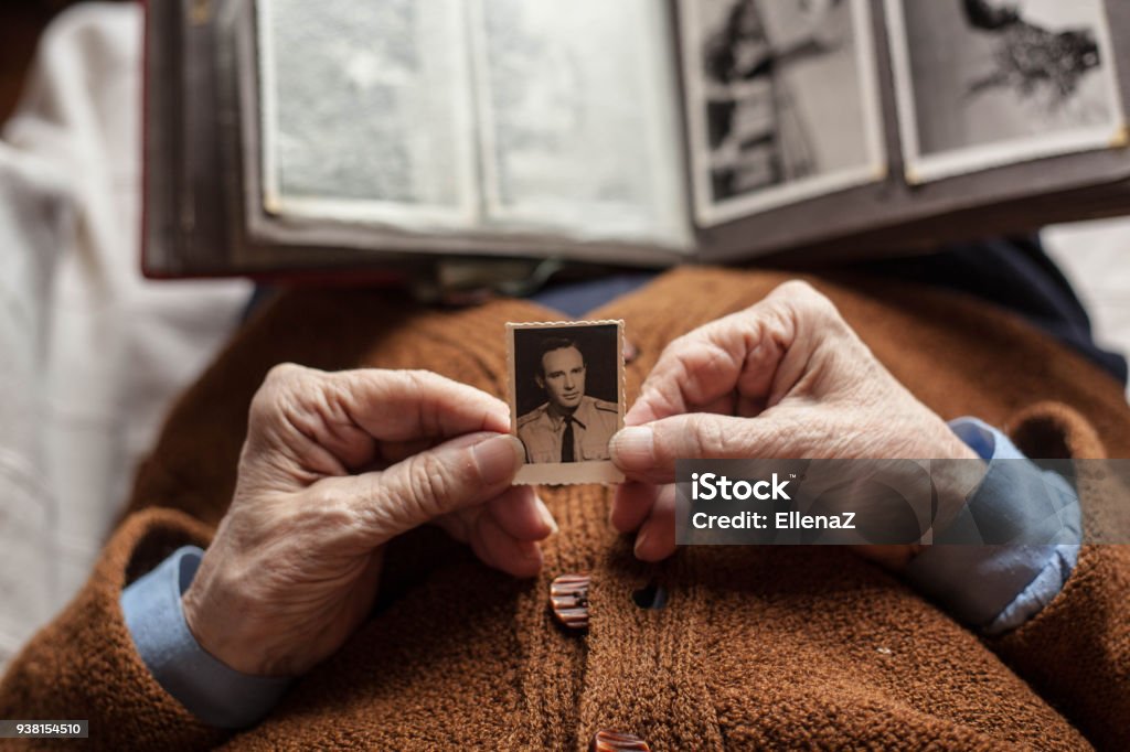 Missing. Senior woman with dear photographs . Memories Stock Photo